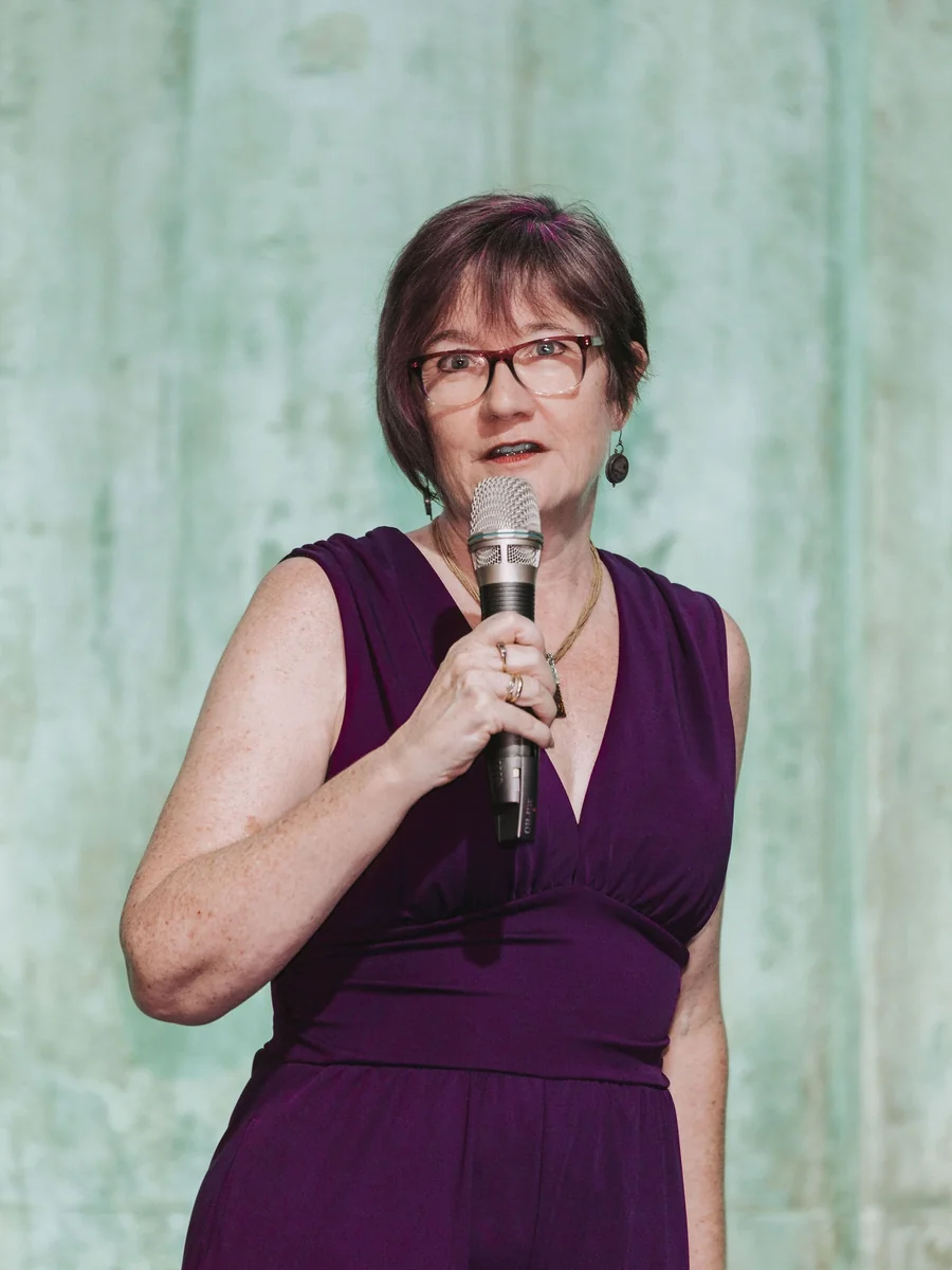 Maya Middlemiss on stage with a microphone at Nomad Summit, Tallinn, July 2026